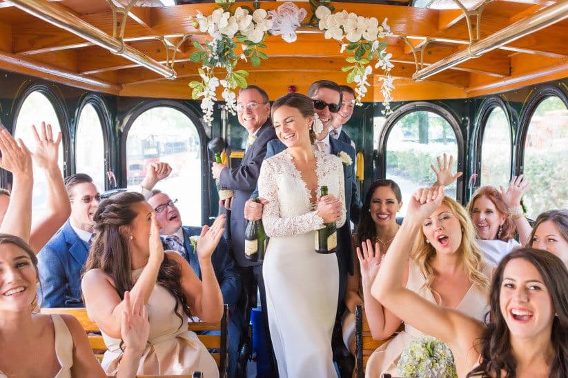 Wedding party toasting and celebrating inside the trolley