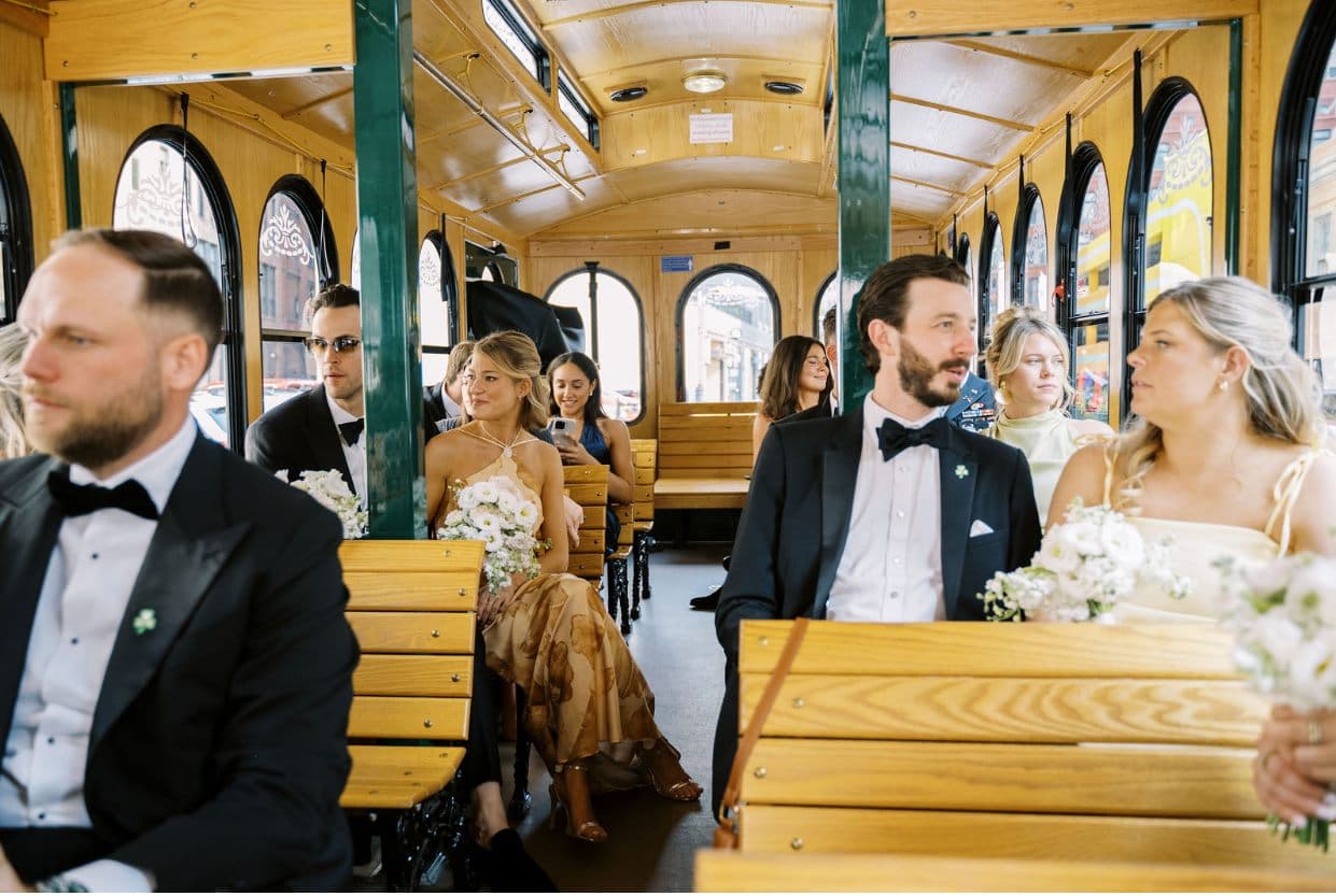 Bride and groom seated inside the warm wooden Golden Trolley