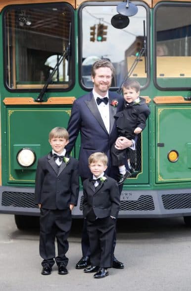 Groom with young ring bearers in front of the trolley